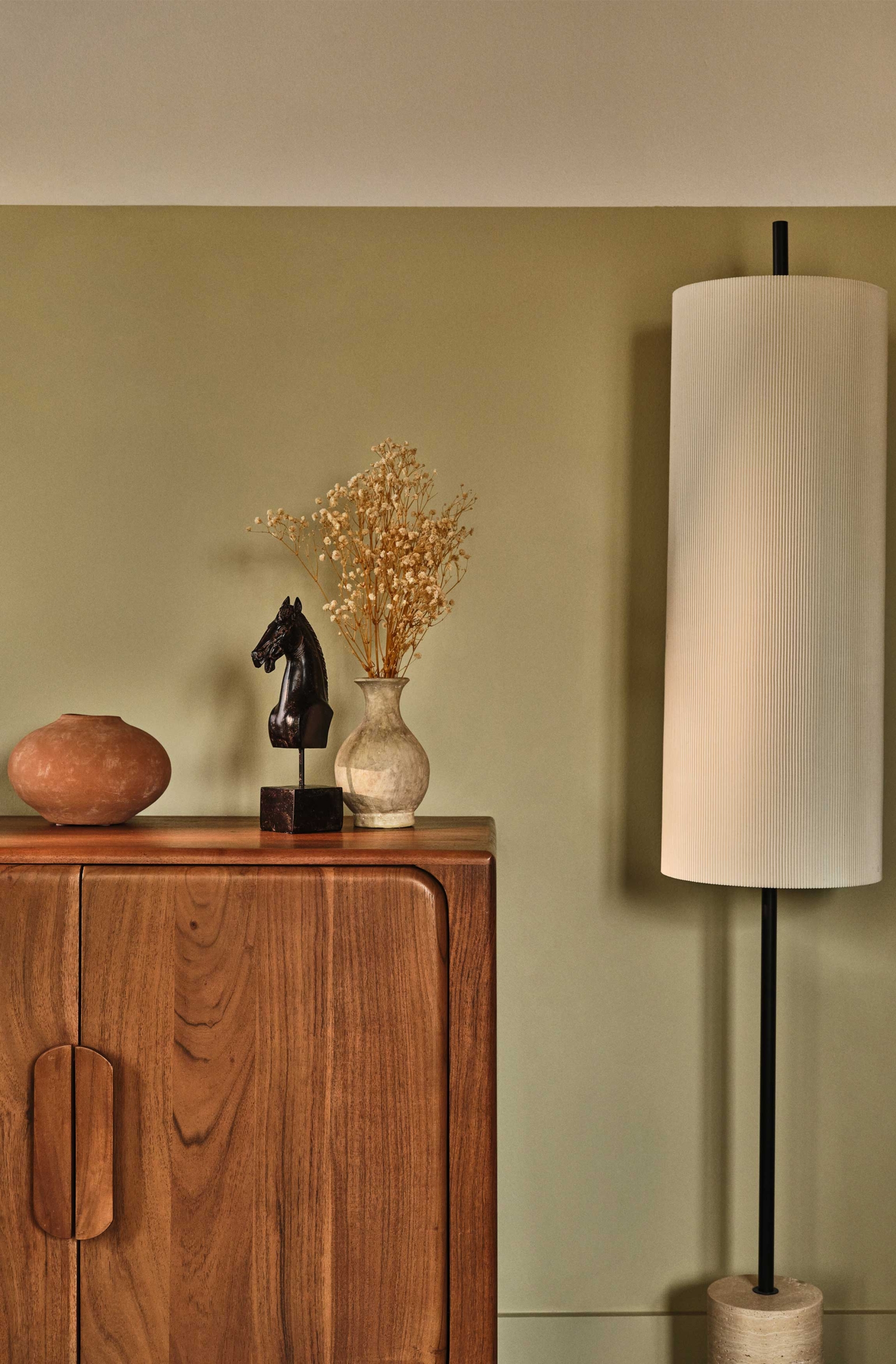 Hutch with decorative items on top and lamp to the right