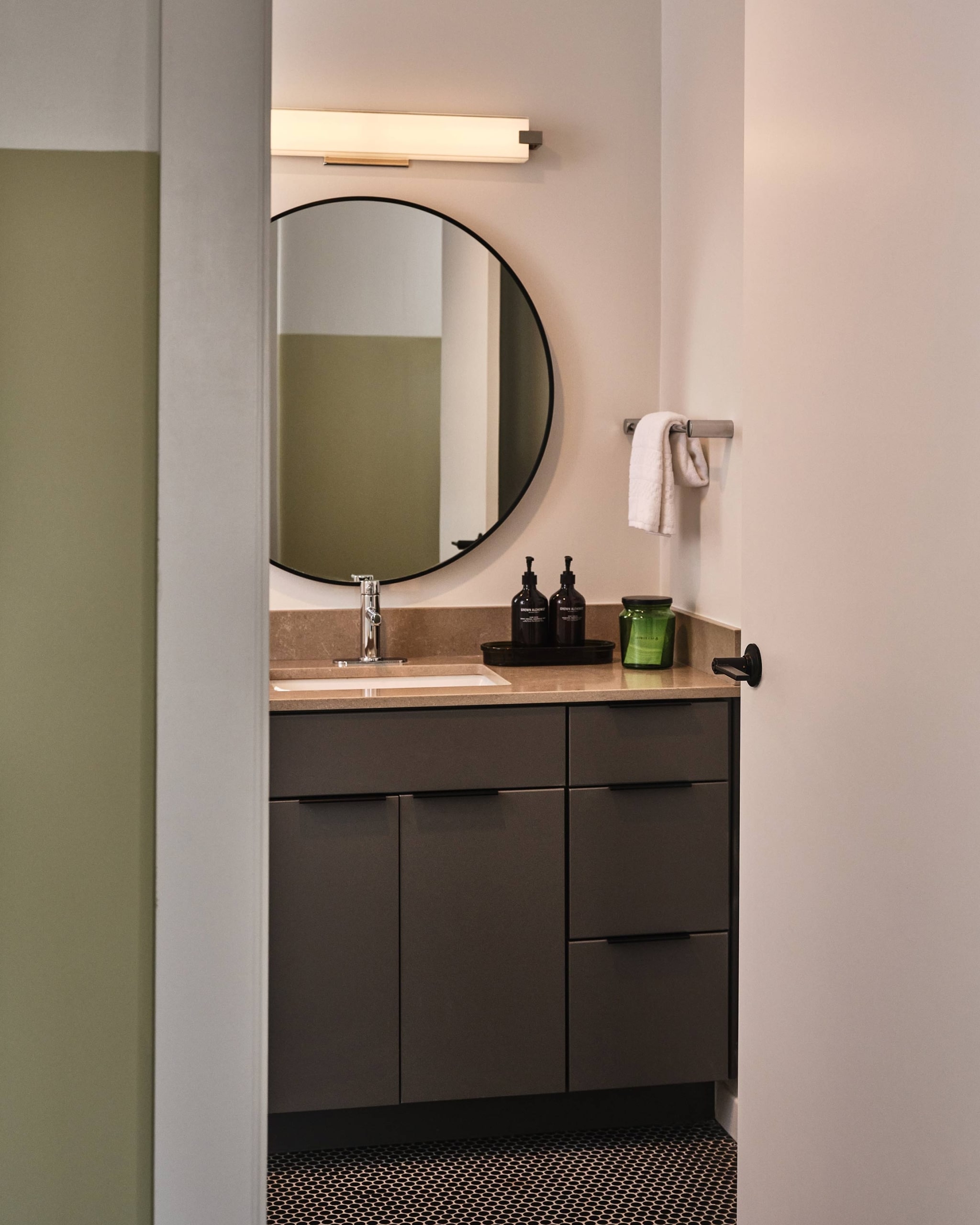 View of bathroom and round mirror vanity