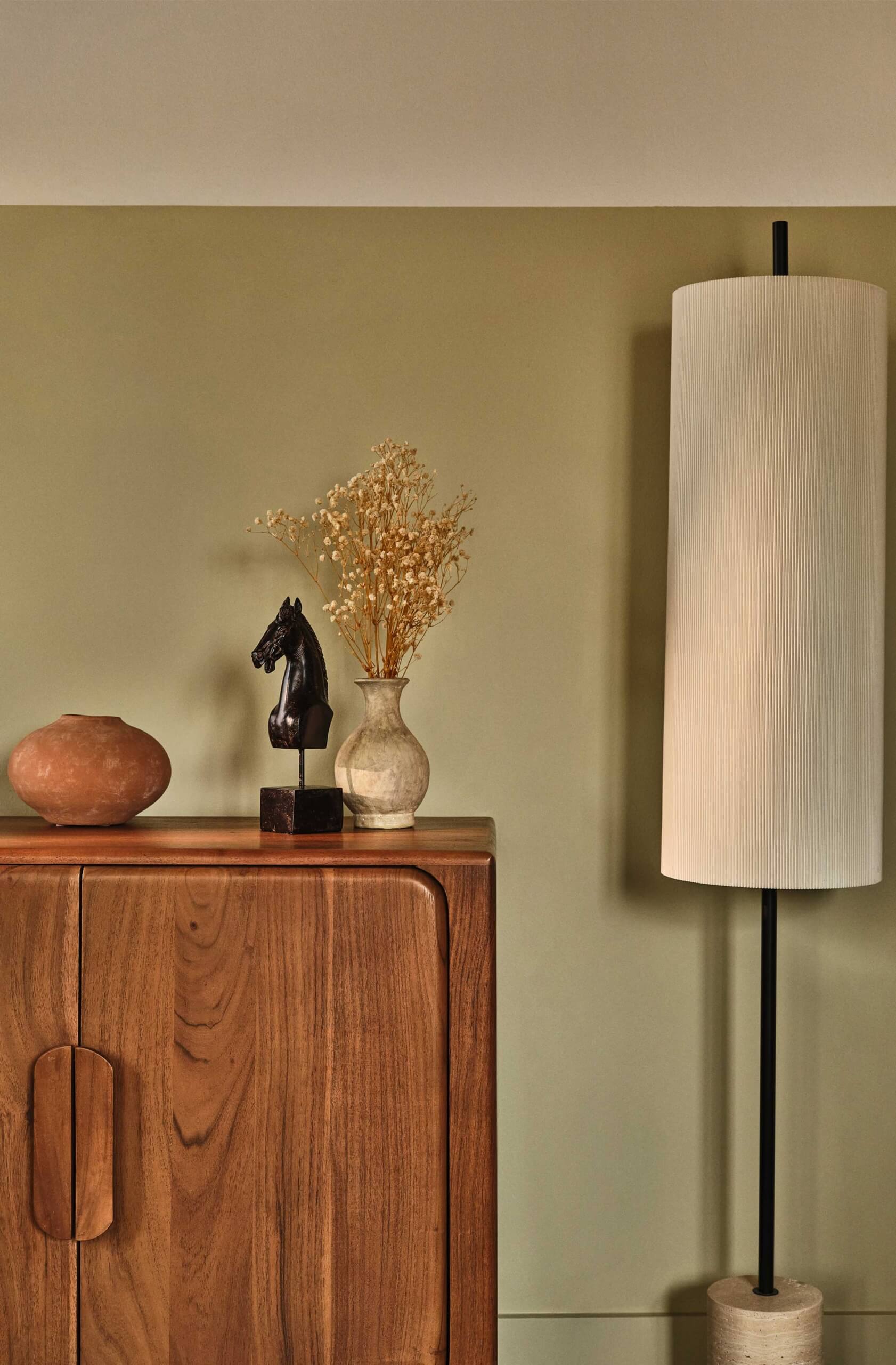 Hutch with decorative items on top and lamp to the right