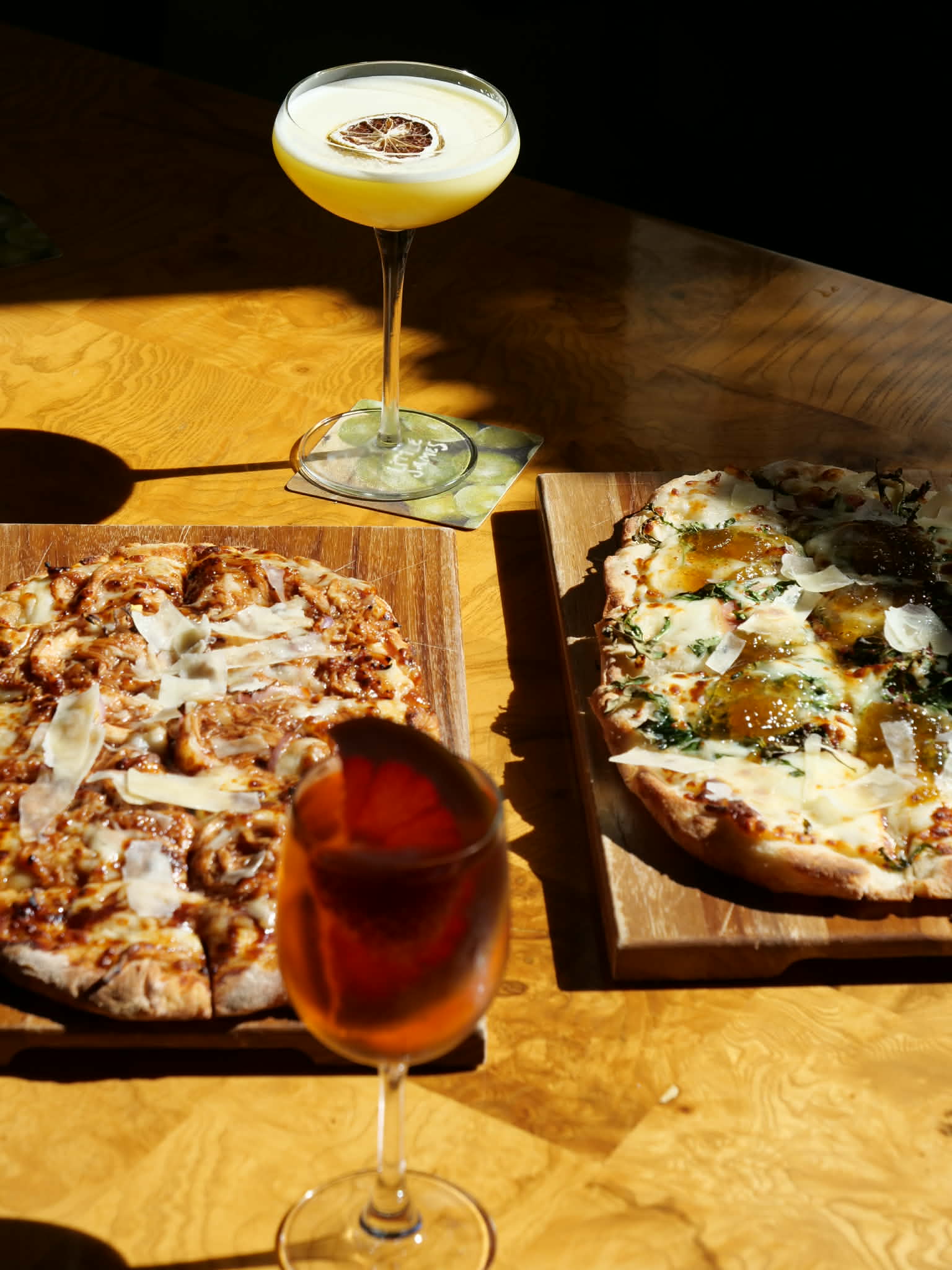 Aperitivo cocktails and wood-fired flatbreads in golden-hour light at Little James, The Ann Savannah